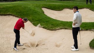 Nick Dougherty and an amateur golfer in a bunker at Wentworth