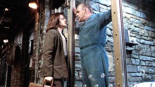 Jodie Foster as Clarice Starling and Anthony Hopkins as Dr. Hannibal Lecter staring at each other in prison during the movie The Silence of the Lambs.