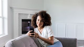 Woman uses smartphone in new home