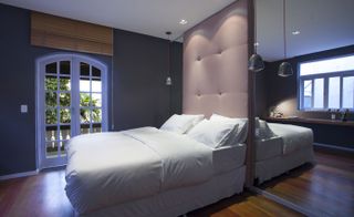 Club house bedroom with white bedlinen and pillow