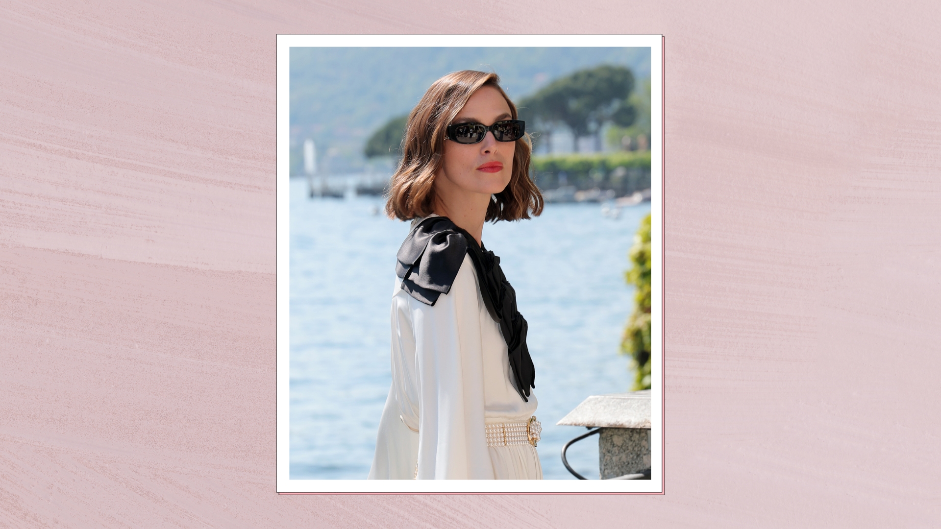 Keira Knightley is pictured with a wavy bob hairstyle and wearing sunglasses, and a white and black dress at the Chanel Cruise 2025 fashion show at Villa D&#039;Este on April 29, 2025 in Como, Italy/ in a pastel purple watercolour paint-style template
