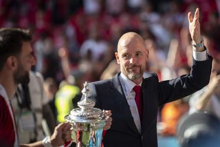 Erik ten Hag celebrates with the FA Cup trophy after Manchester United's win over Manchester City at Wembley in May 2024.