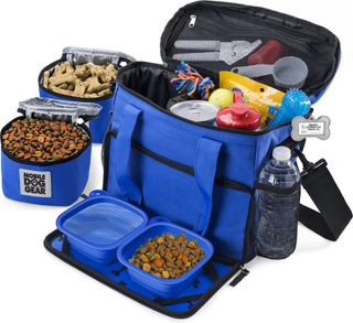 A blue Mobile Dog Gear tote containing food bowls and containers and a mesh pocket