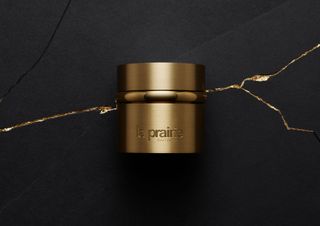 Still life image of La Prairie gold collection bottle