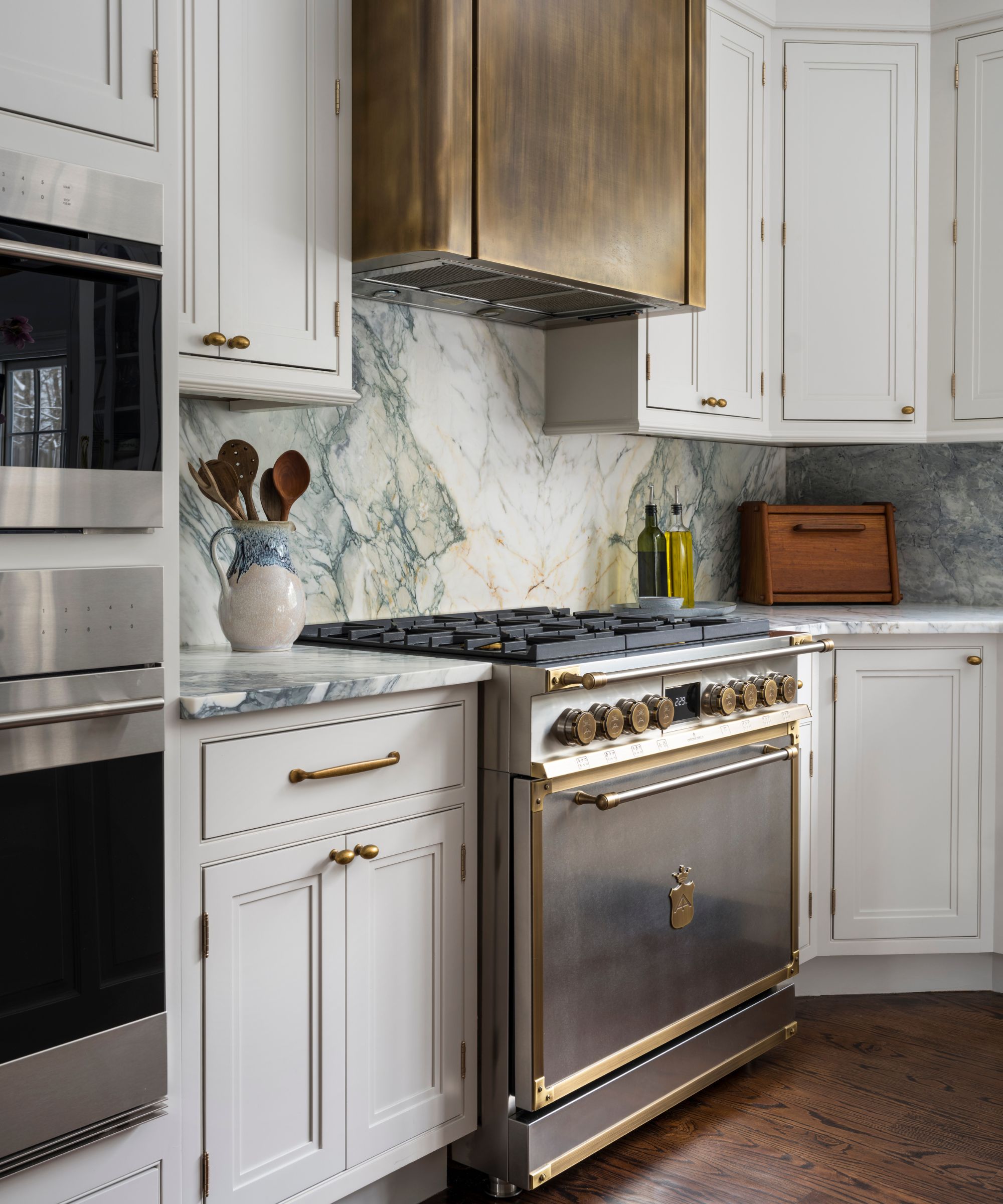 A white shaker kitchen with a stainless steel range cooker