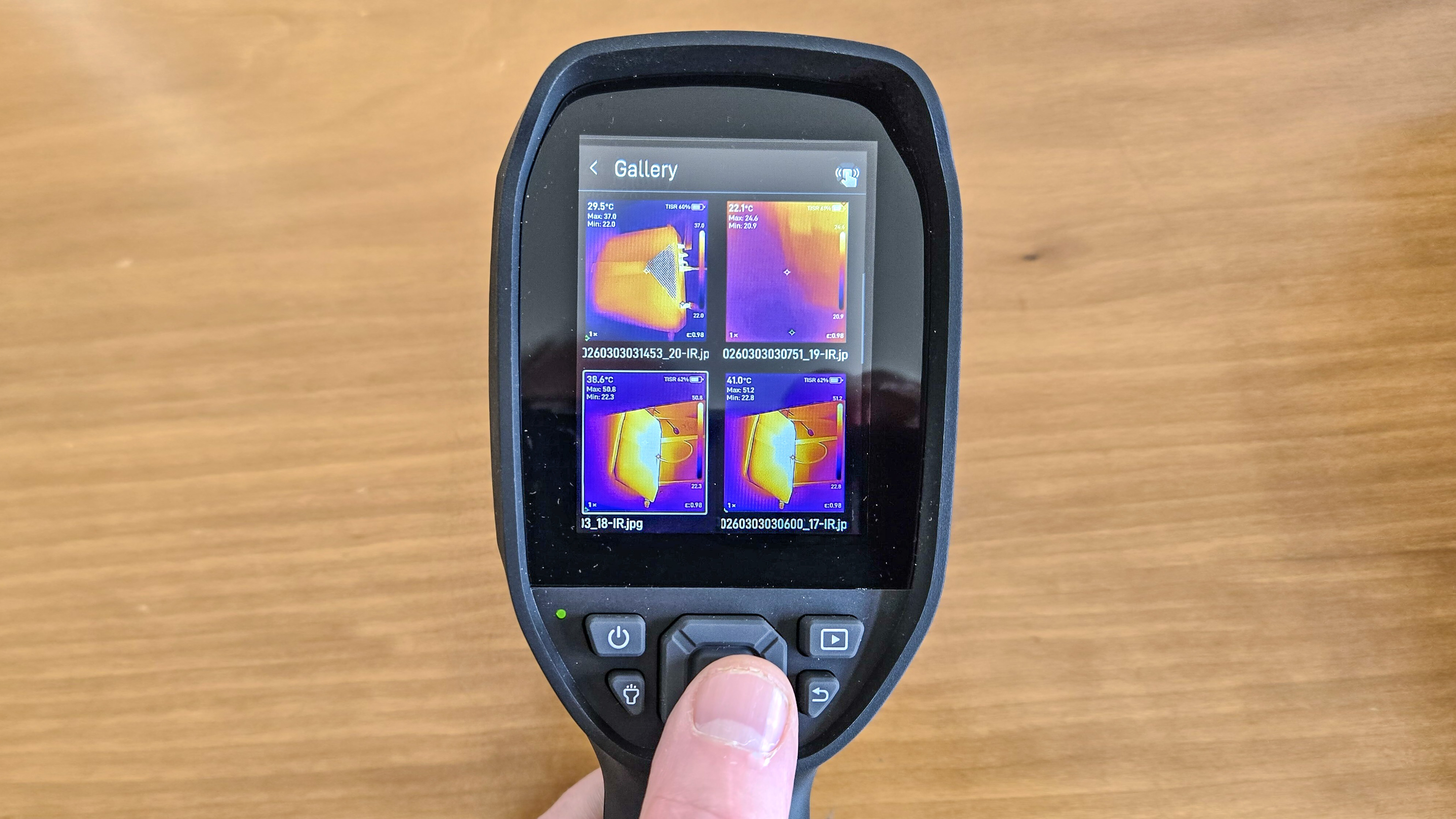 A person holding a thermal imaging camera