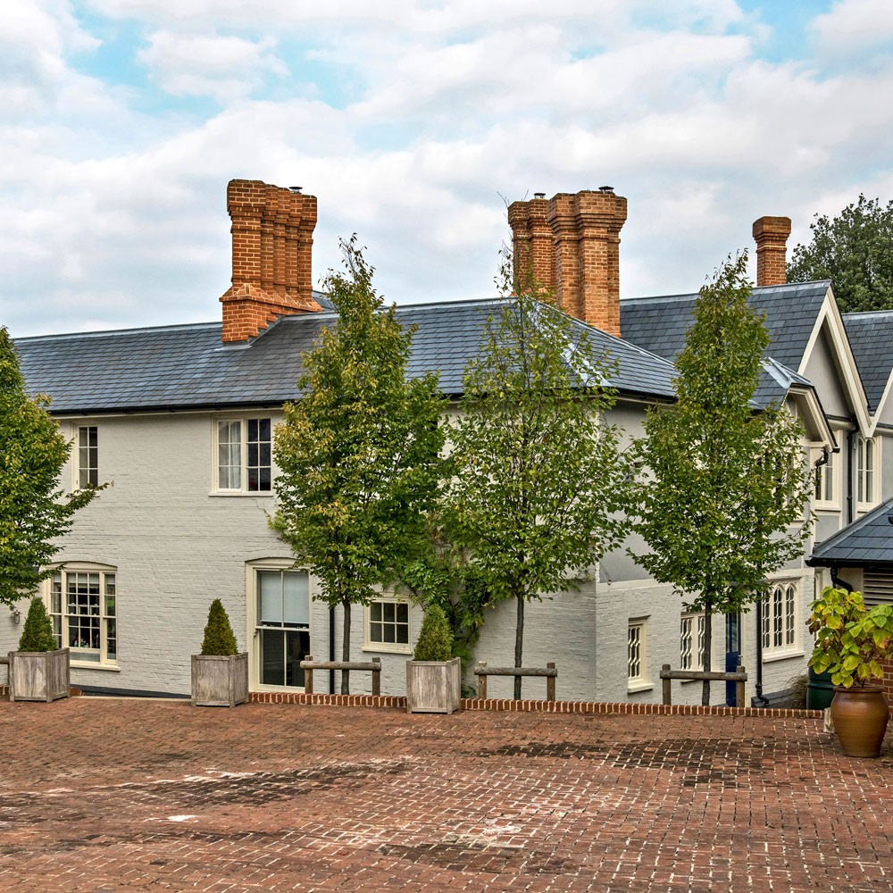 house exterior with plants and white windows