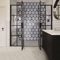 bathroom with monochrome tiles and white sink