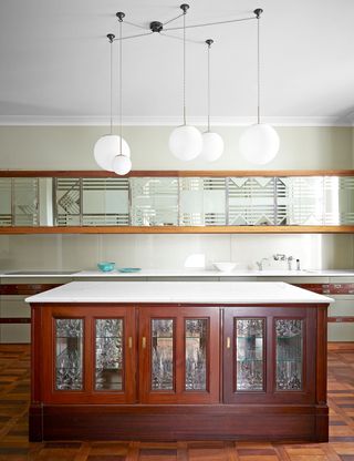 Country kitchen with wood island and mirrored wall