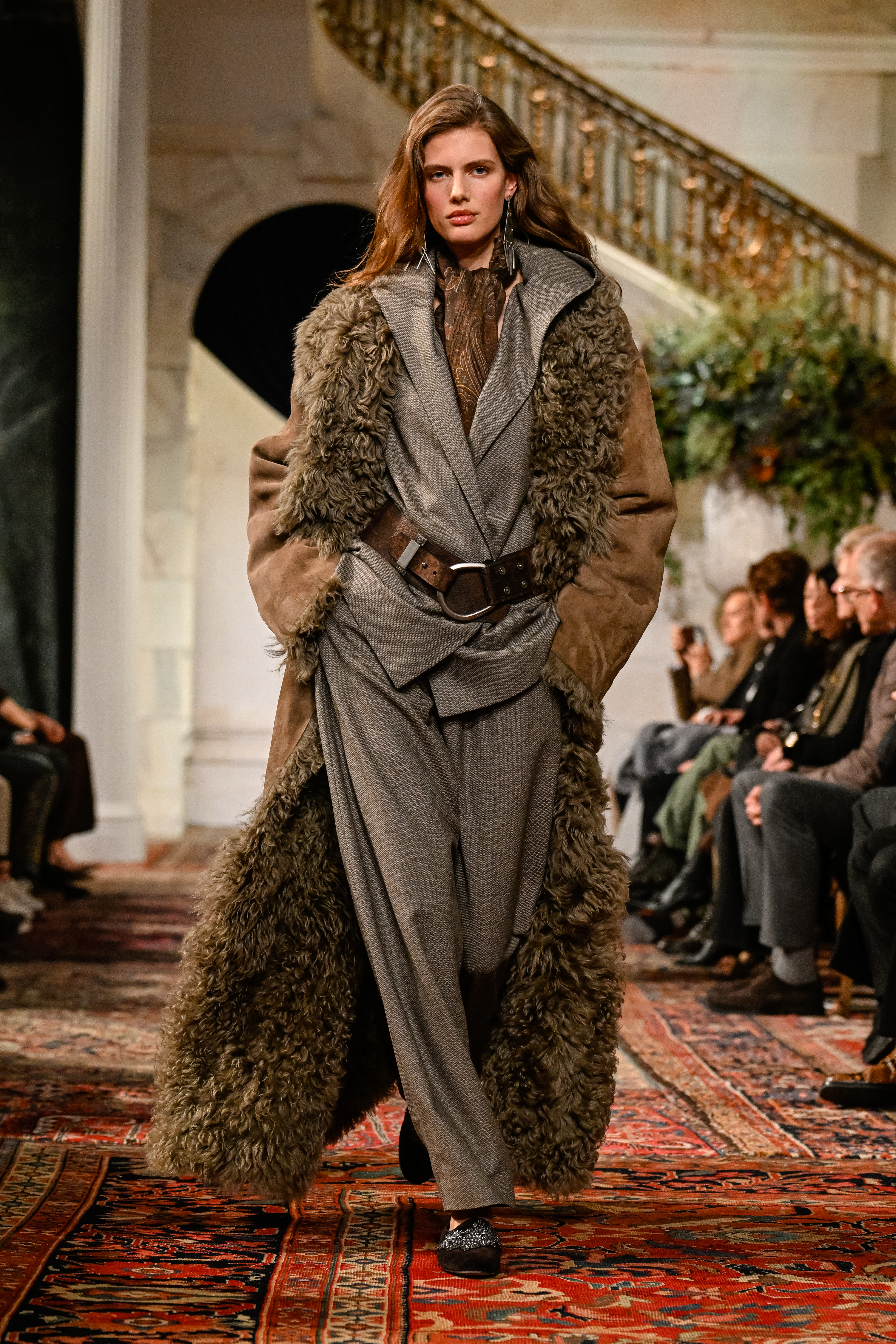 a model wearing a gray suit and a shearling coat at the ralph lauren fall 2026 fashion show