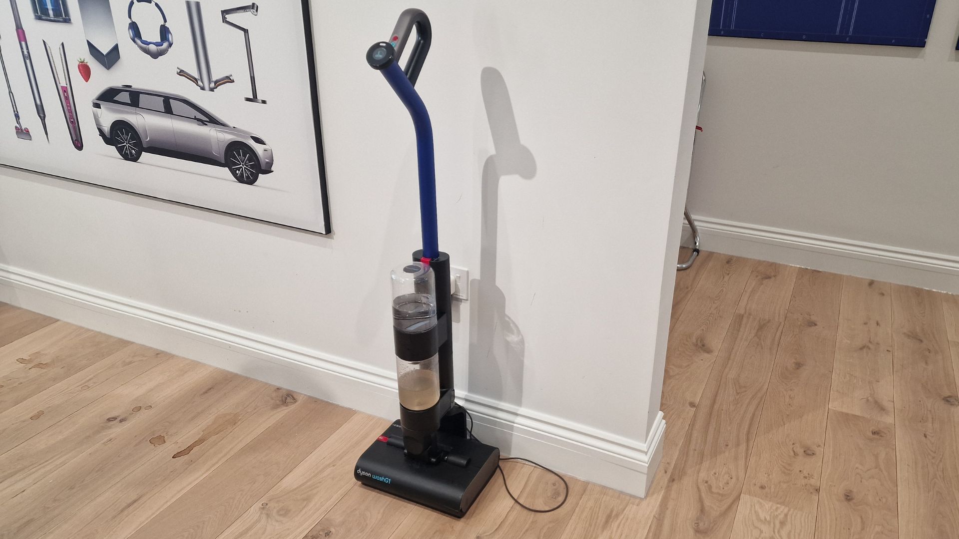 The Dyson WashG1 against a wall in its stand