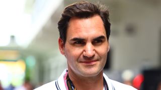 Roger Federer looks on in the Paddock prior to the F1 Grand Prix of Miami