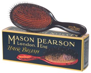 Vintage Mason Pearson brush resting on a box on a white background