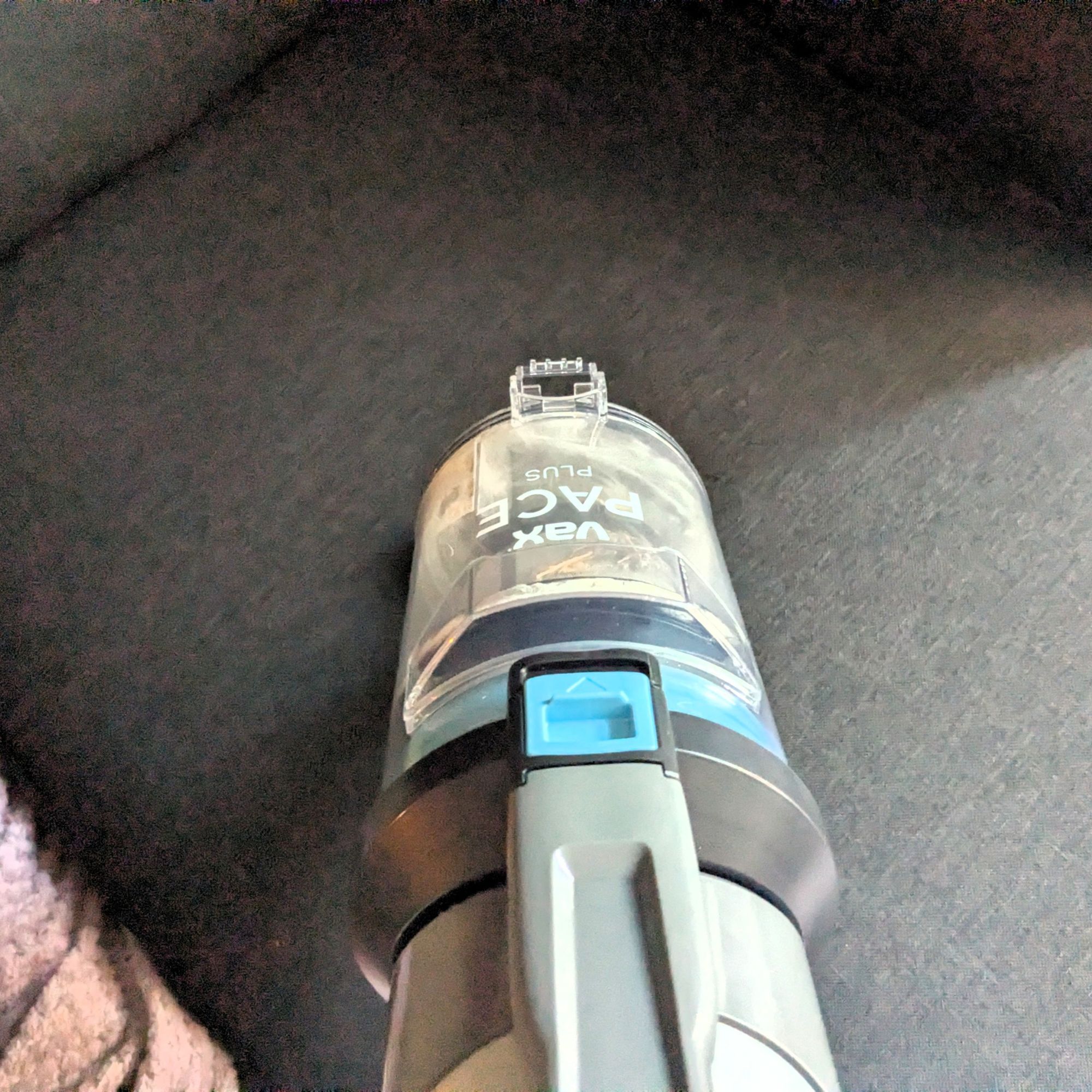 VAX Pace Plus Cordless Vacuum Cleaner handheld cleaning a grey sofa