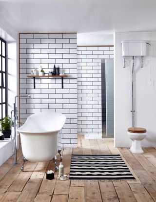 bathroom with subway style tiles and wooden floor