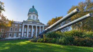 The front entrance of the Imperial War Museum in London with anti-aircraft guns outside