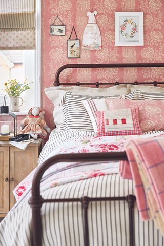 country vintage bedroom with bright pink walls and pink bedding