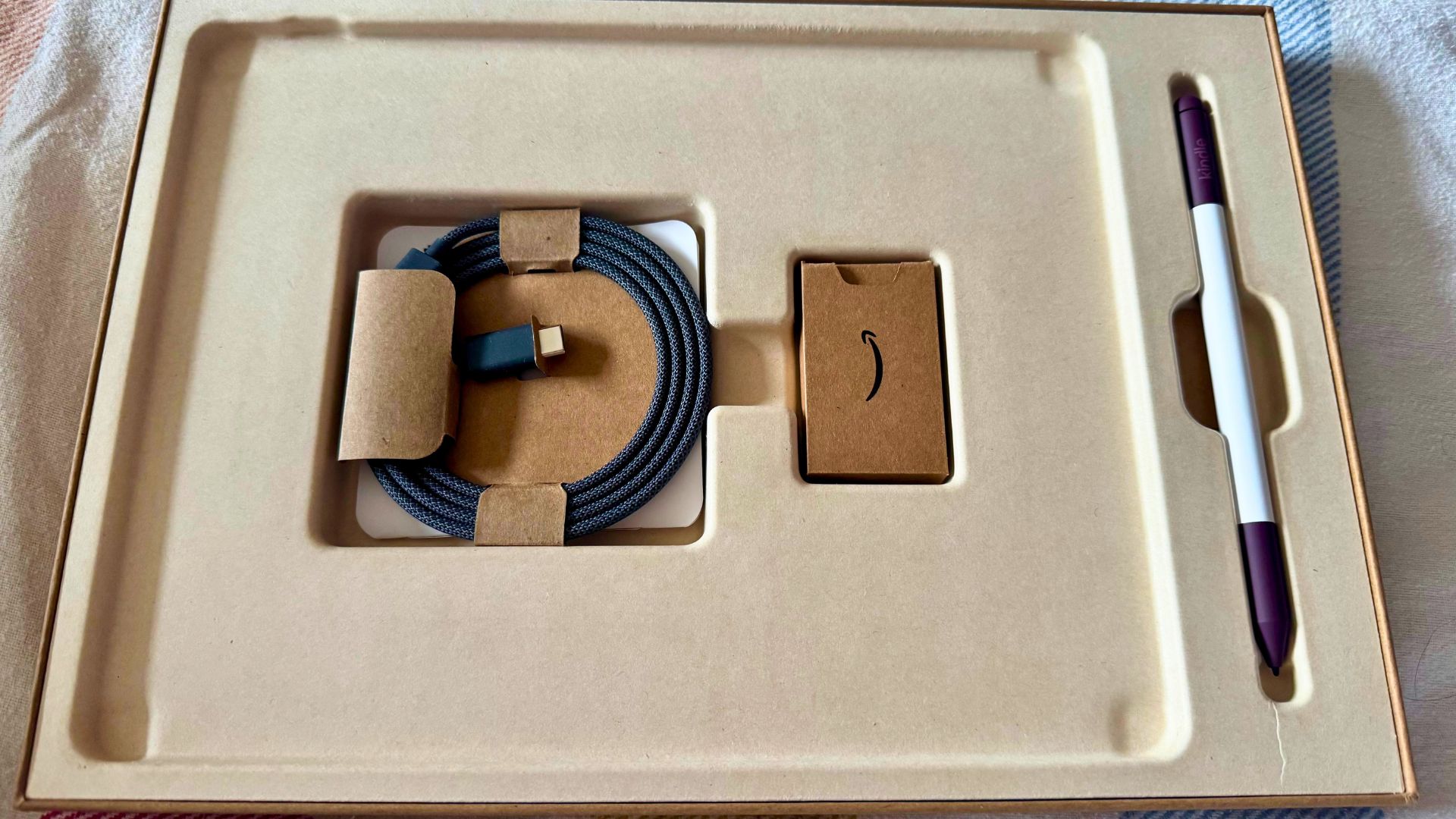 The Amazon Kindle Scribe Colorsoft packaging including the charging cable and pencil