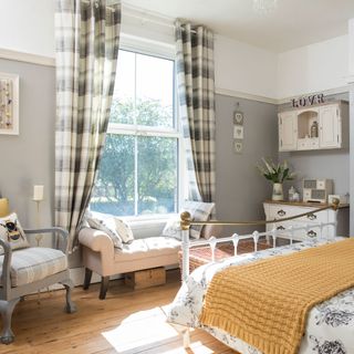 bedroom with checkered curtains and grey walls