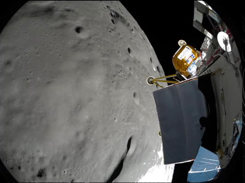 A fisheye view of the moon with a spacecraft to the right of it. There is a yellowish gold box on the craft.