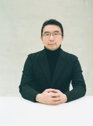 Close up portrait of architect sou fujimoto in plain white background