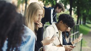 Teenagers using smartphones