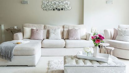 living room with white walls and white sofa.