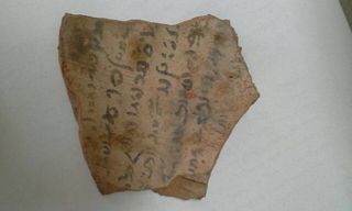 A piece of pottery with ancient Egyptian writing on it. The text has not yet been deciphered.