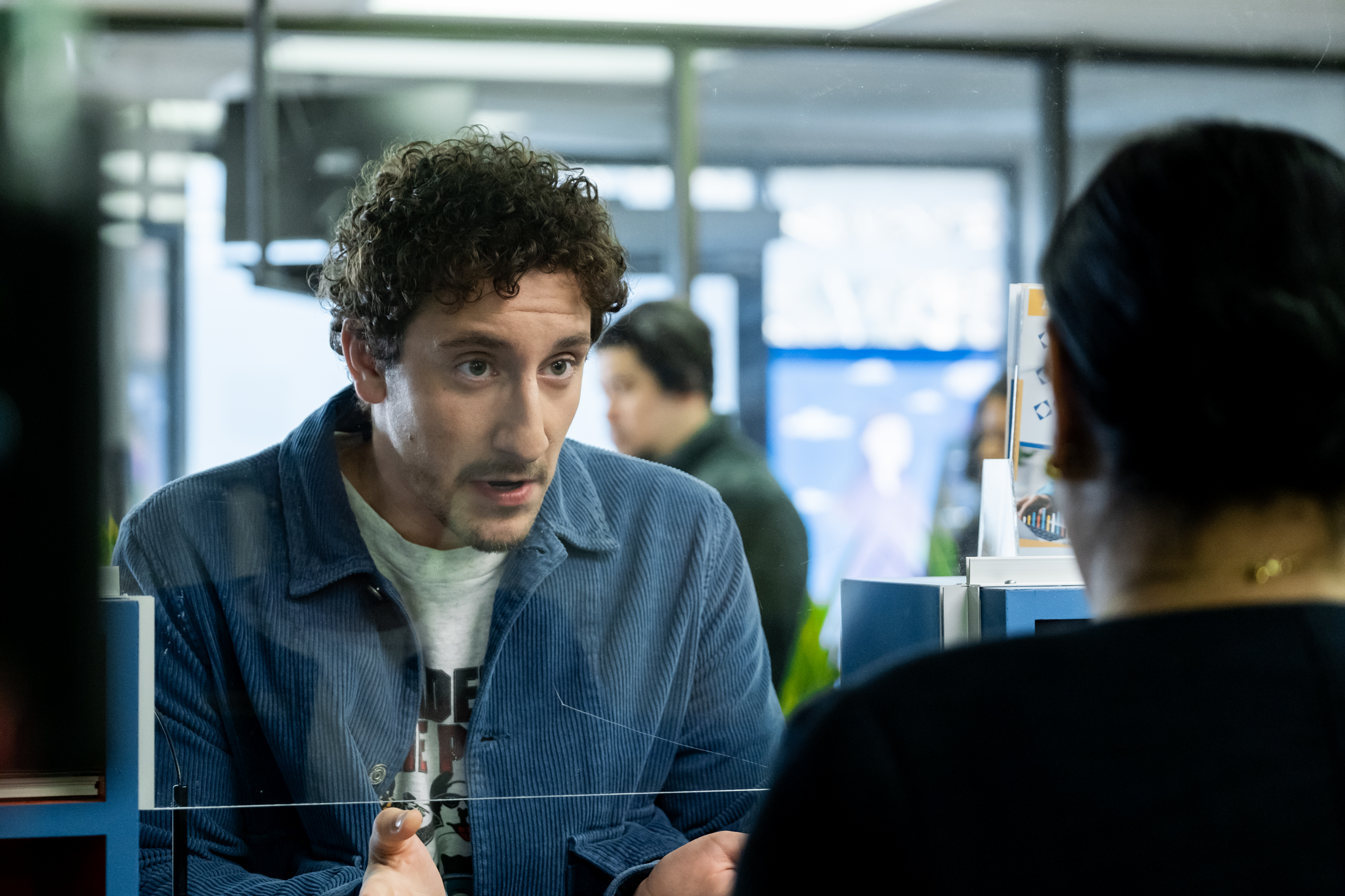 Malik Elassal as Samir, talking to a bank teller, in 'Adults.'