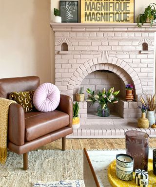 Pink living room with brick fireplace, flowers and homeware accessories