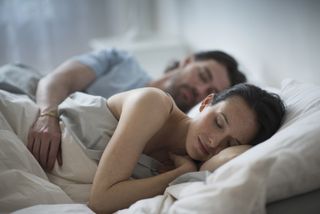 Couple in the spooning position in bed