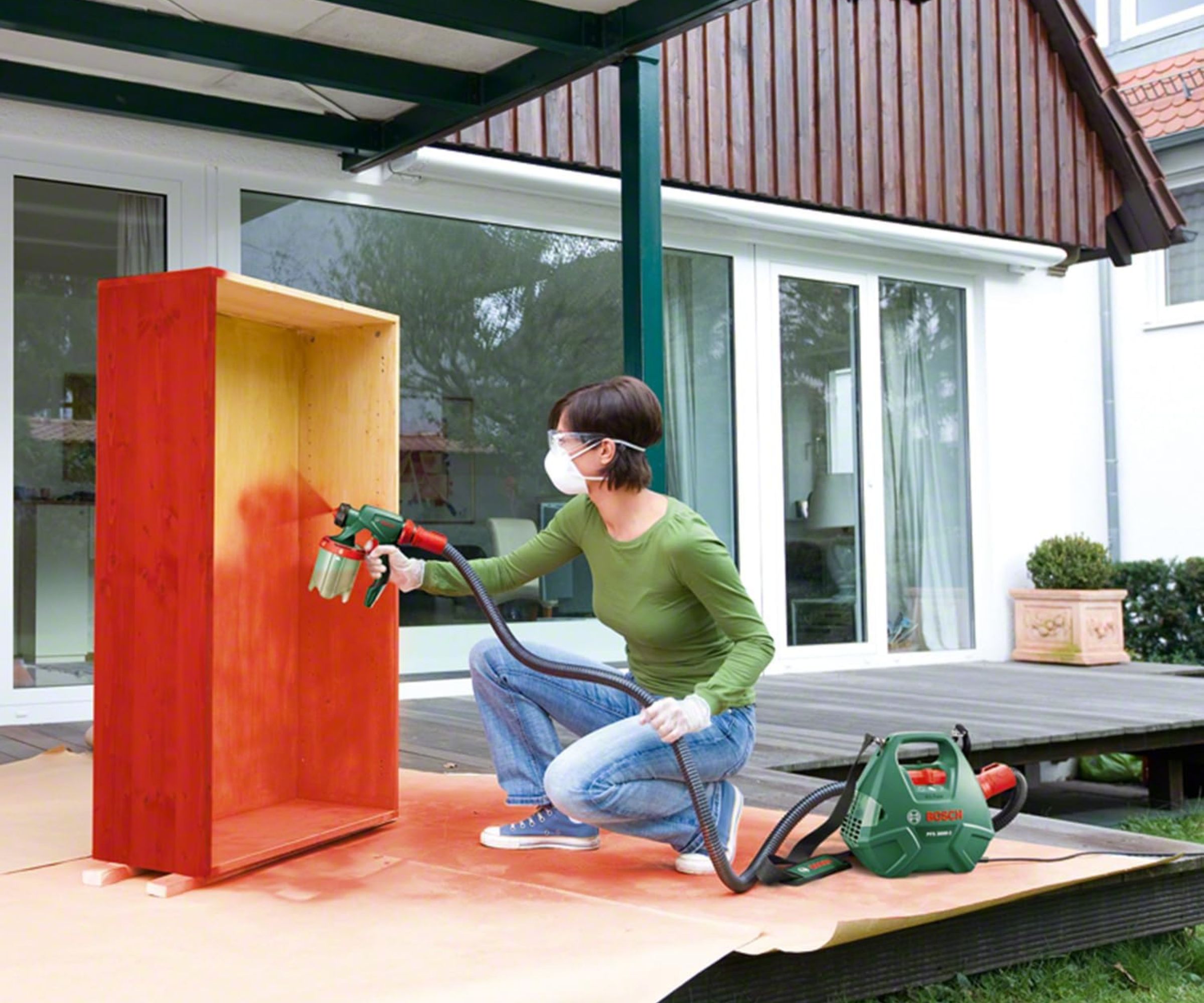 Bosch Home and Garden 603207170 Electric Paint Spray System being used on furniture