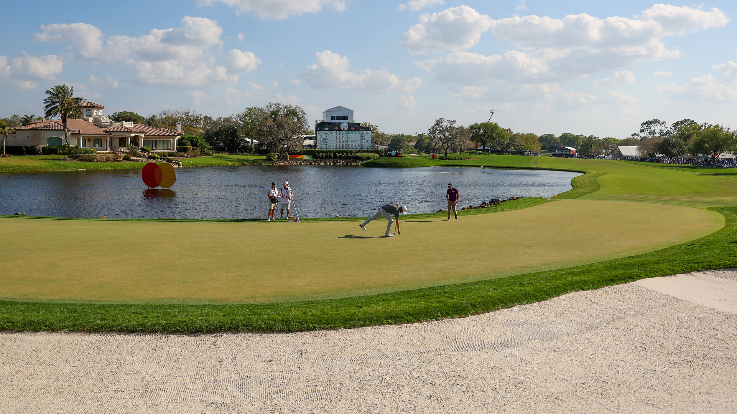 A general view of Bay Hill's 18th hole as Viktor Hovland picks his golf ball out of the hole in 2025