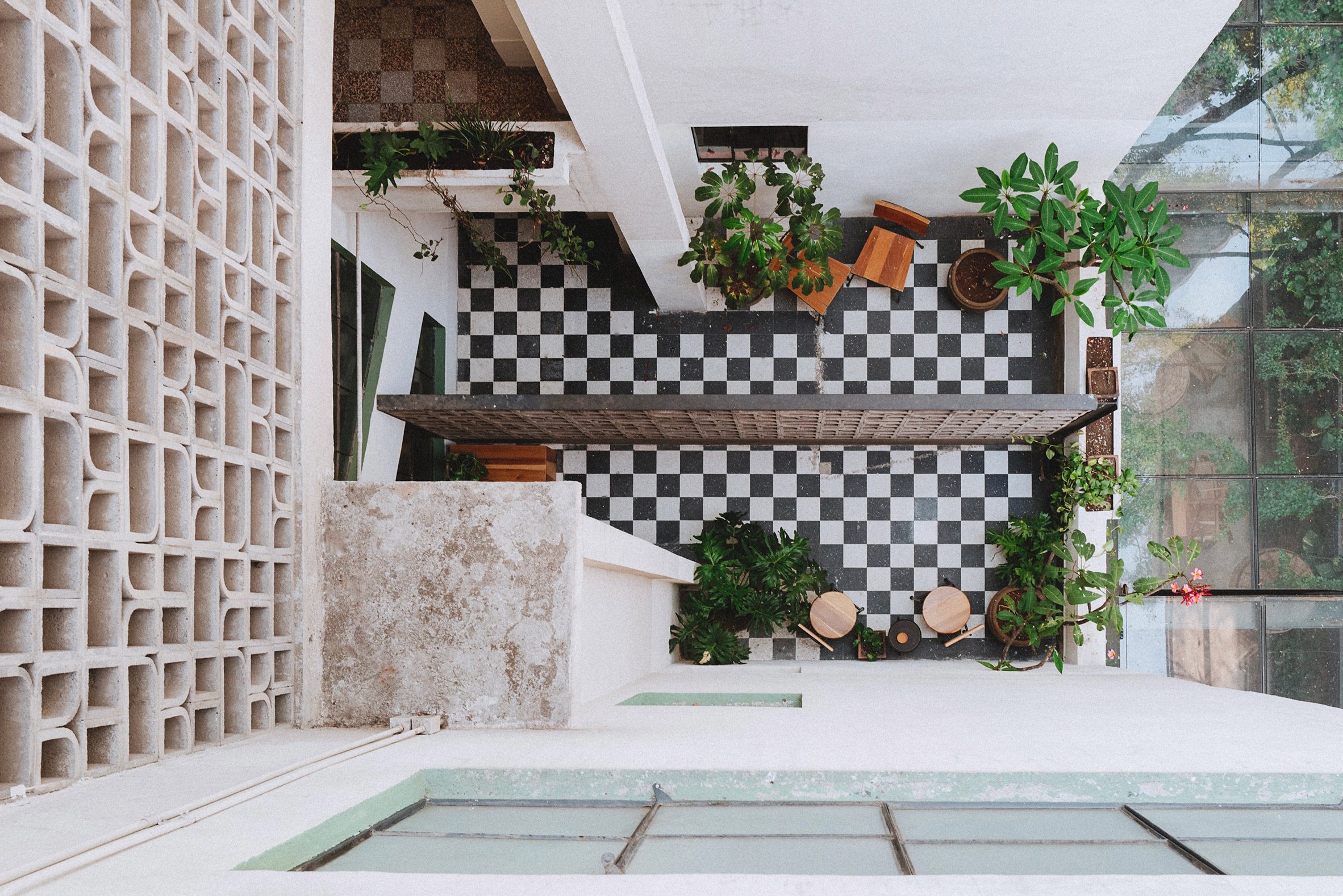 A vibrantly decorated hotel featuring a pastel palette of pinks, greens, and browns, tiled surfaces, and a vaguely Art Deco, contemporary feel.