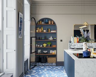 Modern kitchen with arch doorway leading to pantry, kitchen island