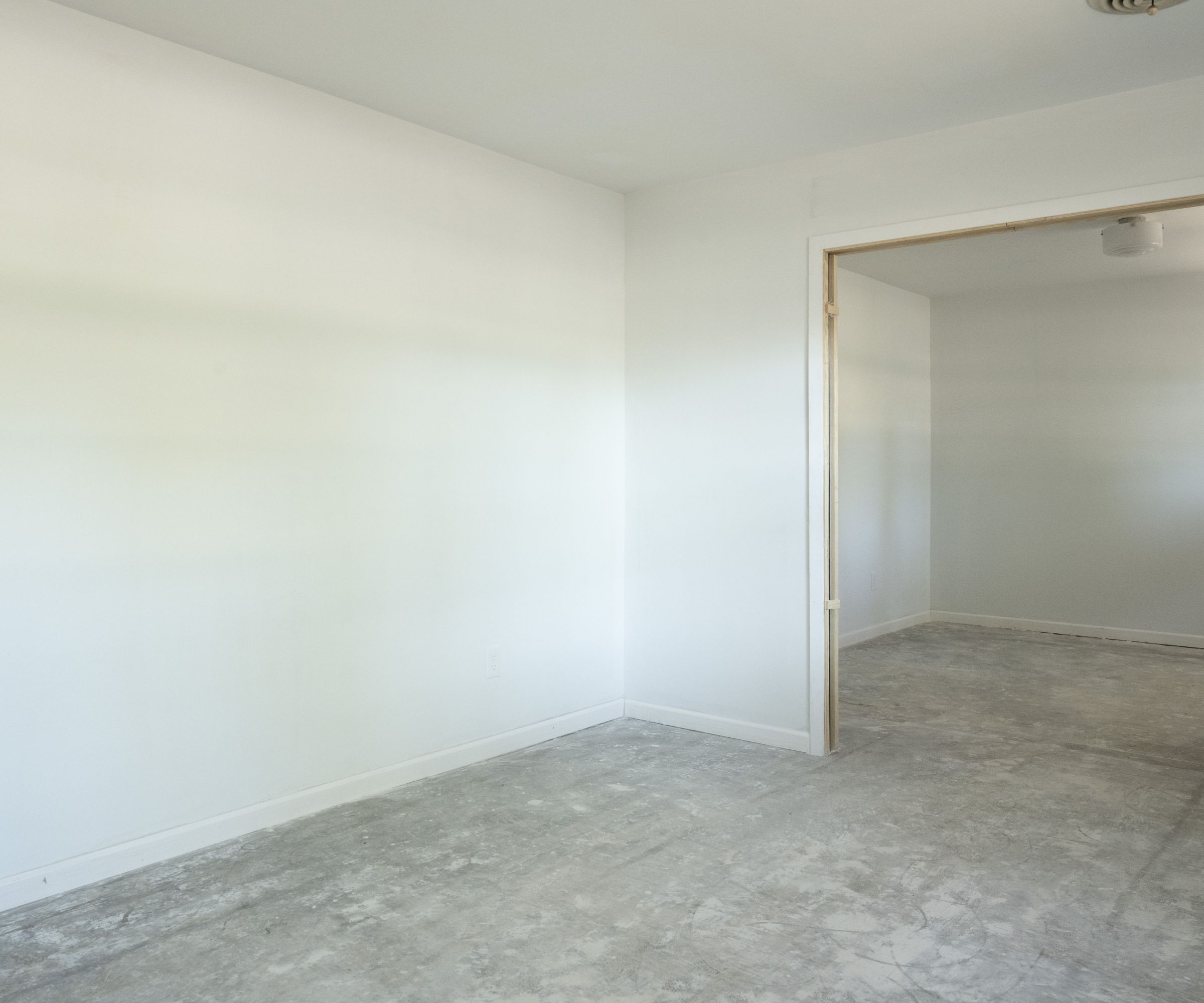 Empty room with white walls, carpet and doorway