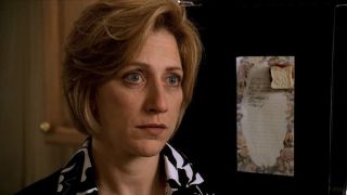 Edie Falco standing by the fridge, looking upset, in The Sopranos