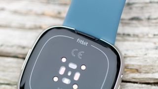 Close-up on Fitbit logo above Versa 4 sensors