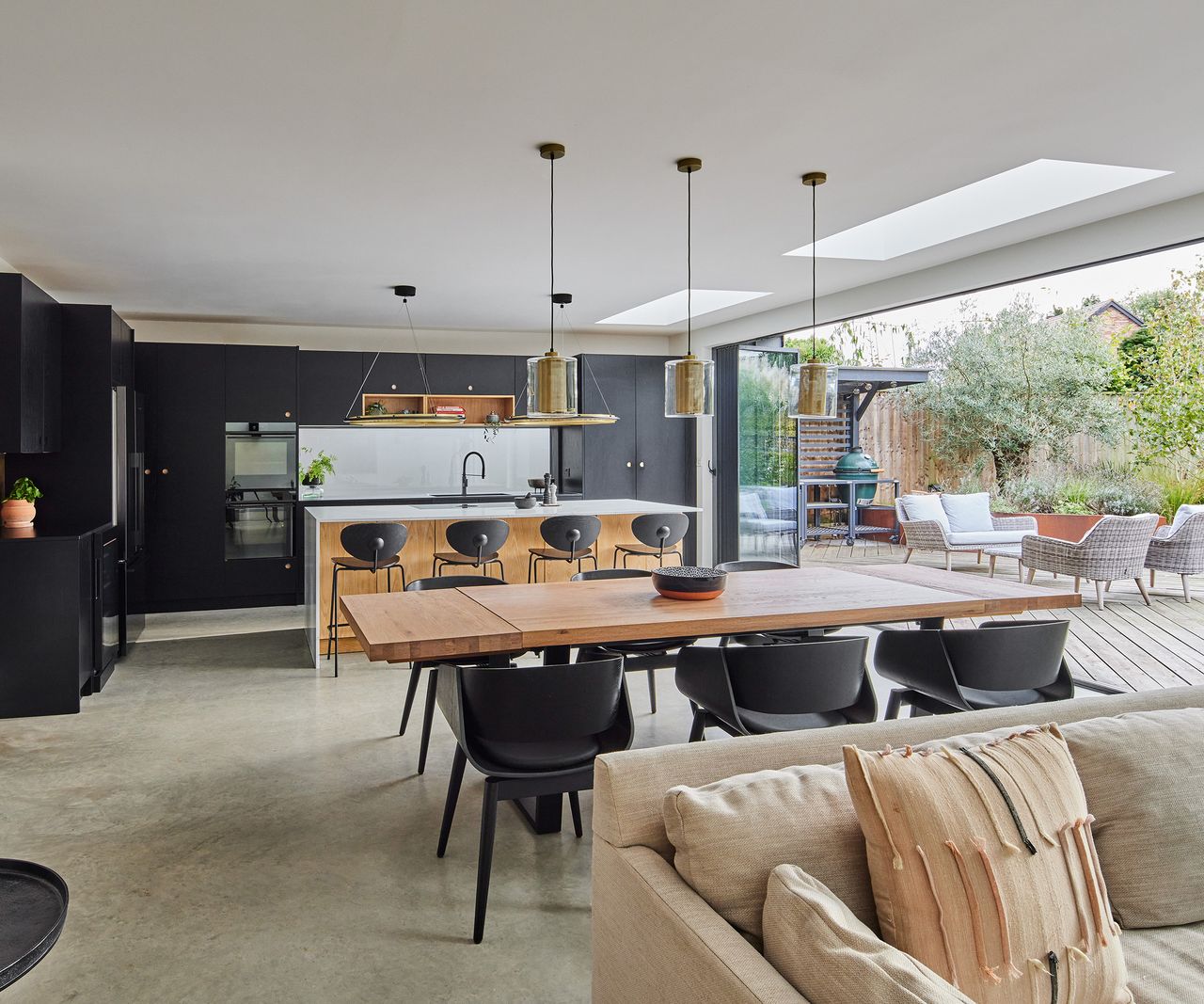 A large open plan kitchen, diner and lounge. There are bifold doors which open completely out onto a patio