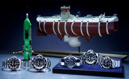 Rolex Oyster Perpetual Deepsea Challenge among other Rolex watches in front of models of Deepsea Challenger submersible and the bathyscaphe Trieste