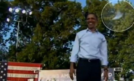 A book zooms by President Obama's head after his speech in Philadelphia.