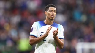 Liverpool target Jude Bellingham applauds fans after his side's World Cup defeat to France in Qatar.