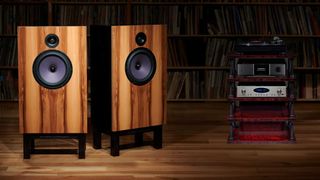 De Vore speakers with other hi-fi electronics in a dark room with vinyl records