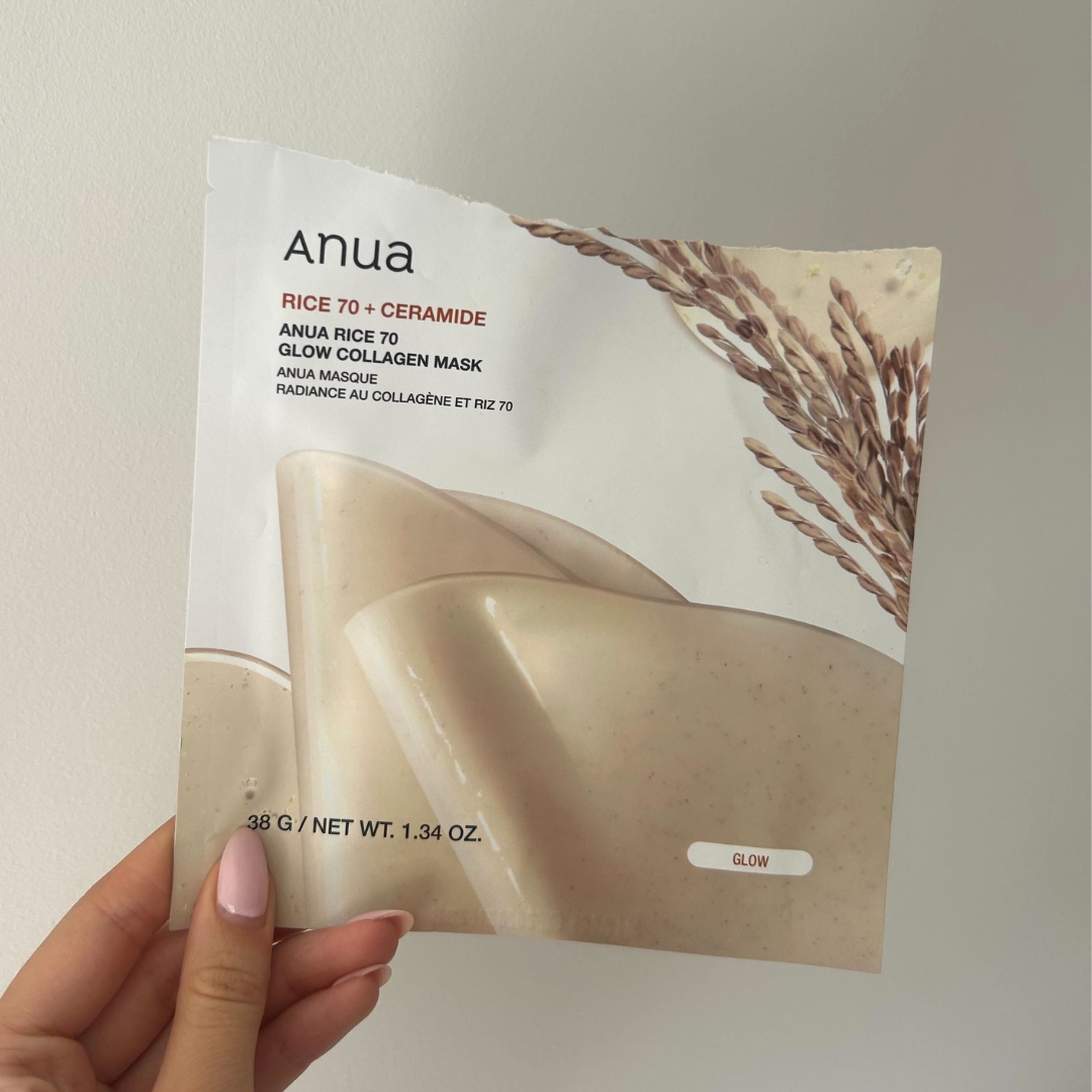 Hand holding empty sachet of Anua Rice 70 Glow Collagen Mask