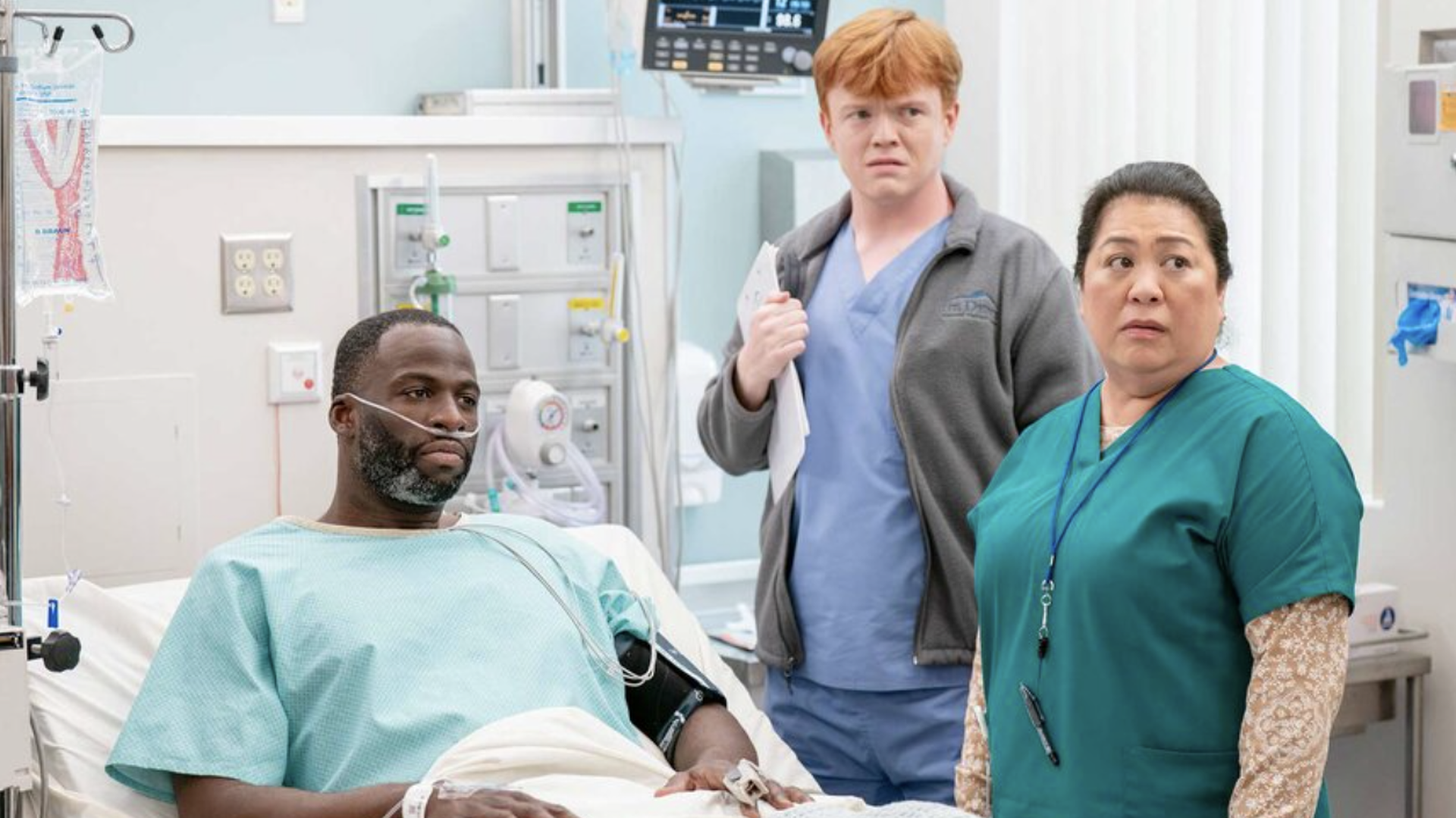 A patient (Draymond Green) accompanied by nurse Val (Kaliko Kauahi) in St. Denis Medical season 2