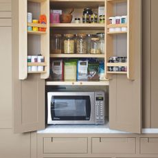 cupboard with microwave and glass jars