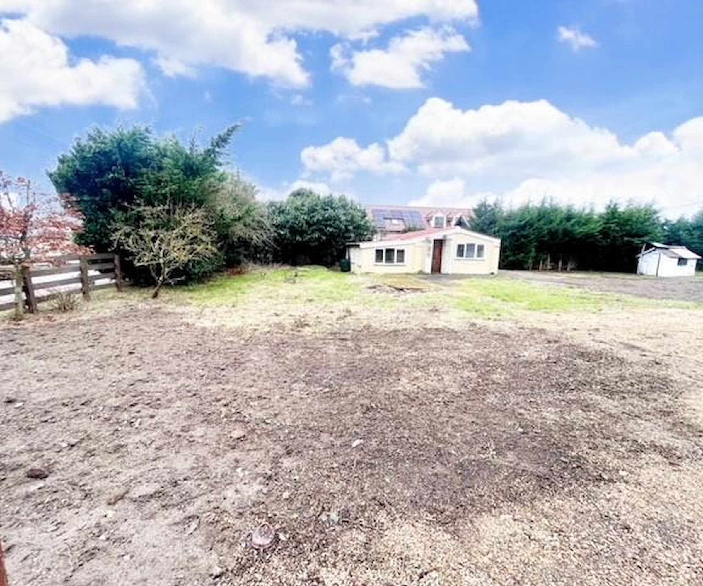 A plot with a house and garden used for training horses