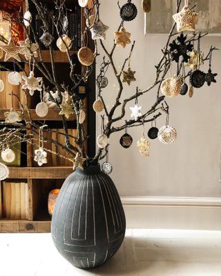 hand made Christmas decorations on twig branches in a black vase