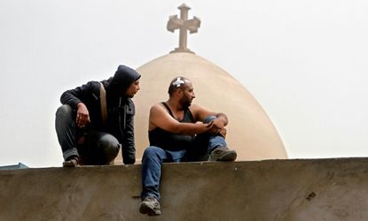 Egyptian Christians sit on the wall of the Coptic cathedral in Cairo, April 8.