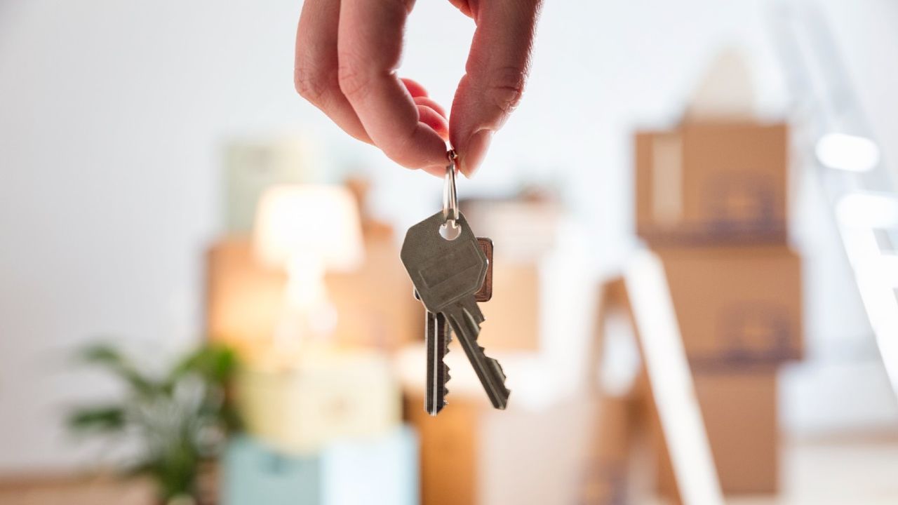 Hand holding keys to a home